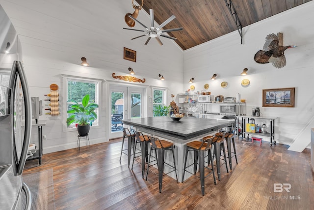 30857 Cypress St, Perdido Beach, AL 36530 - dining room featuring dark wood-style floors, healthy amount of natural light, ceiling fan, wooden ceiling, and high vaulted ceiling