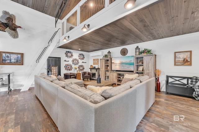 30857 Cypress St, Perdido Beach, AL 36530 - living room featuring wood finished floors, a wall mounted air conditioner, and wood ceiling