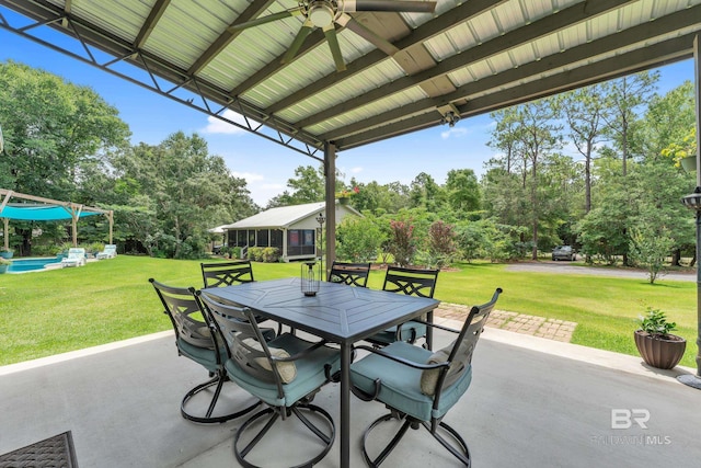 30857 Cypress St, Perdido Beach, AL 36530 - view of patio / terrace featuring outdoor dining space, ceiling fan, view of scattered trees, and an outdoor pool