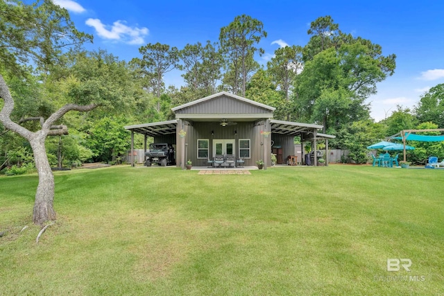 30857 Cypress St, Perdido Beach, AL 36530 - back of property with a yard, ceiling fan, and board and batten siding
