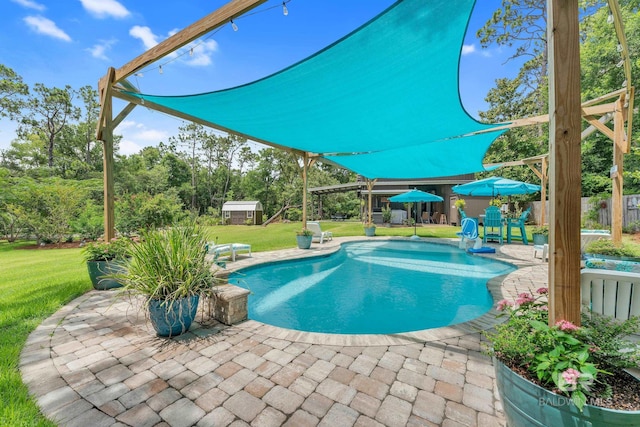 30857 Cypress St, Perdido Beach, AL 36530 - outdoor pool featuring a patio, an outdoor structure, and view of wooded area
