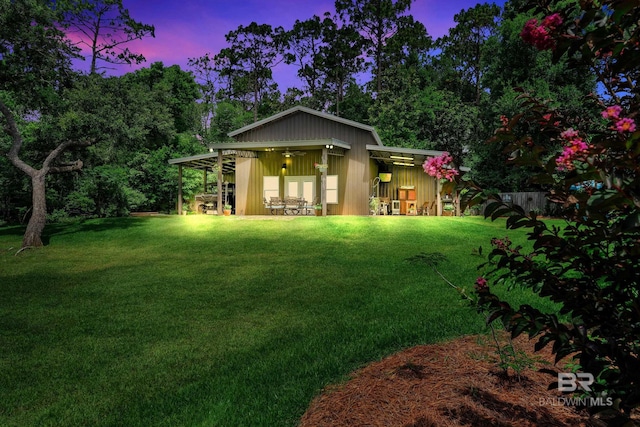 30857 Cypress St, Perdido Beach, AL 36530 - rear view of house featuring a yard, a ceiling fan, and board and batten siding