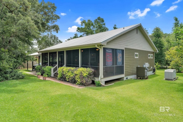 30857 Cypress St, Perdido Beach, AL 36530 - back of property with a sunroom and a lawn
