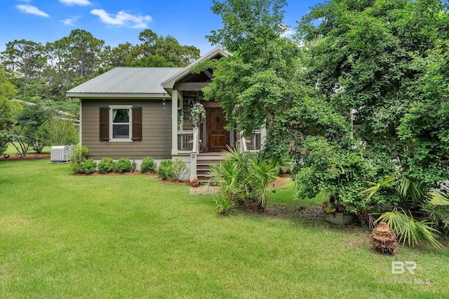 30857 Cypress St, Perdido Beach, AL 36530 - view of front of property featuring a front lawn, a metal roof, and covered porch