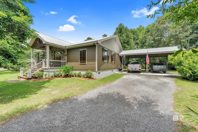 30857 Cypress St, Perdido Beach, AL 36530 - view of home's exterior with crawl space, covered porch, a yard, a metal roof, and gravel driveway