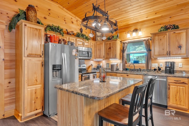 30857 Cypress St, Perdido Beach, AL 36530 - kitchen with stainless steel appliances, vaulted ceiling, wooden ceiling, wood walls, and dark wood finished floors
