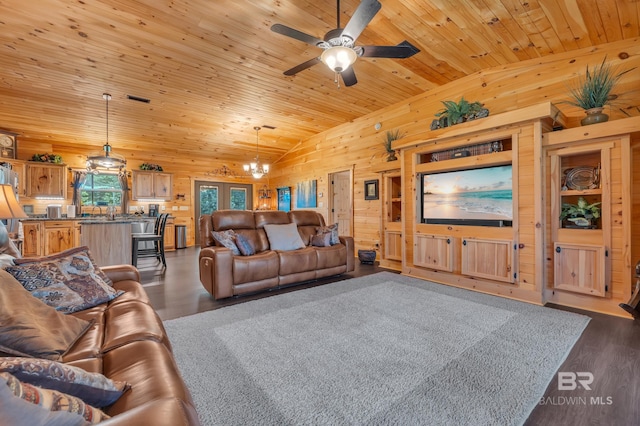 30857 Cypress St, Perdido Beach, AL 36530 - living room featuring wood walls, a chandelier, wooden ceiling, dark wood finished floors, and a ceiling fan