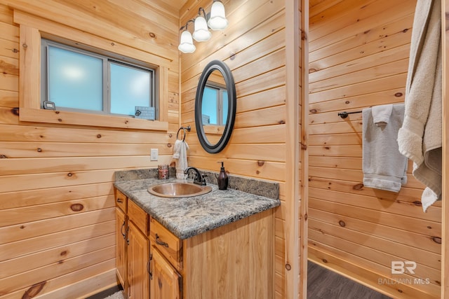 30857 Cypress St, Perdido Beach, AL 36530 - bathroom featuring wood walls, vanity, and wood finished floors