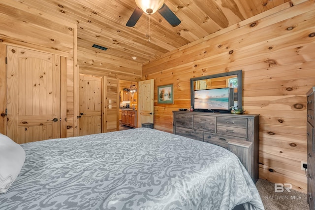 30857 Cypress St, Perdido Beach, AL 36530 - carpeted bedroom with wood ceiling, wood walls, and ceiling fan
