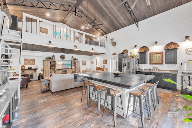 30857 Cypress St, Perdido Beach, AL 36530 - kitchen featuring stainless steel fridge with ice dispenser, high vaulted ceiling, wood finished floors, a ceiling fan, and wooden ceiling