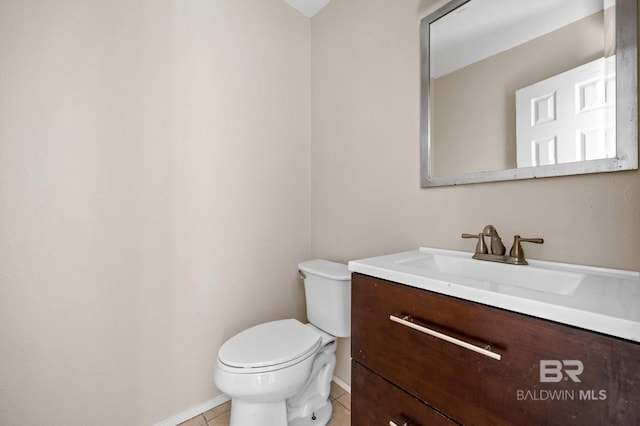 bathroom featuring tile patterned flooring, vanity, and toilet