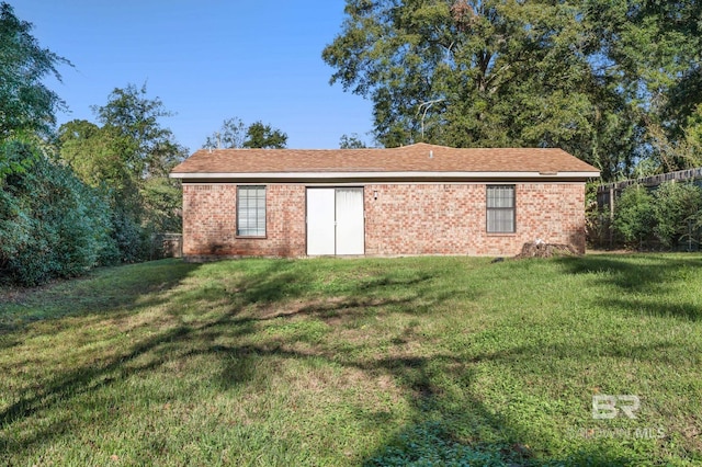 view of outbuilding with a yard