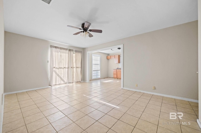 spare room featuring ceiling fan and light tile patterned floors