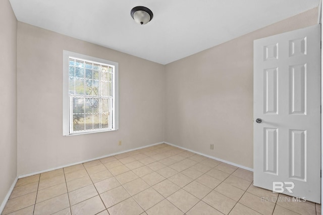 empty room with light tile patterned floors