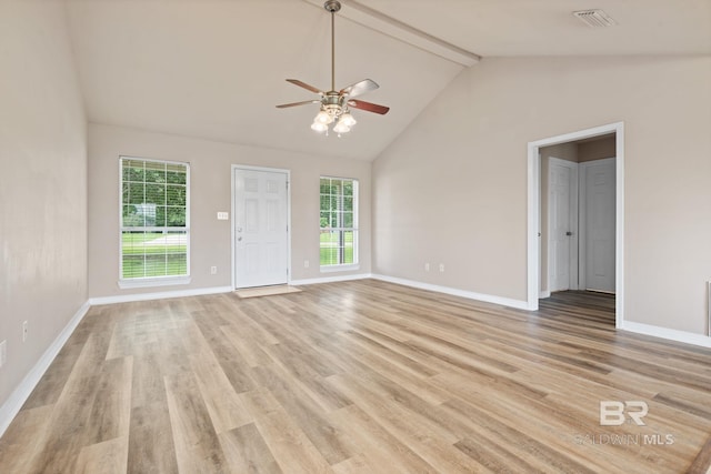 10966 Brighton Dr, Chunchula, AL 36521 - unfurnished living room featuring a ceiling fan, light wood-style flooring, beam ceiling, plenty of natural light, and baseboards