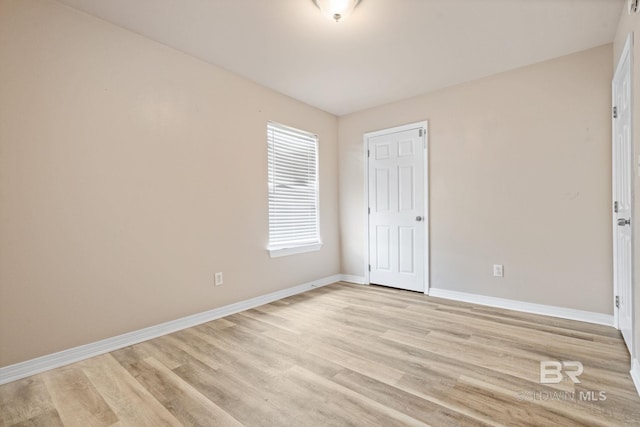 10966 Brighton Dr, Chunchula, AL 36521 - unfurnished bedroom featuring baseboards and light wood-type flooring