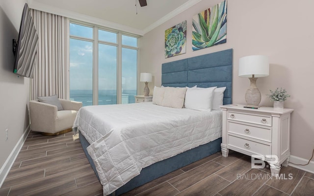 bedroom featuring crown molding, baseboards, a ceiling fan, and wood finish floors