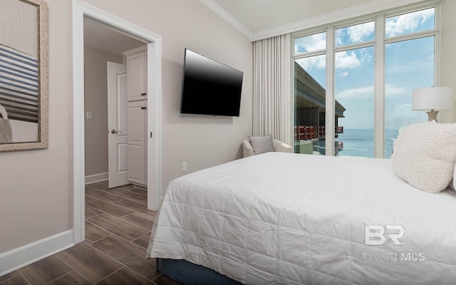 bedroom with crown molding, access to outside, baseboards, and wood finish floors