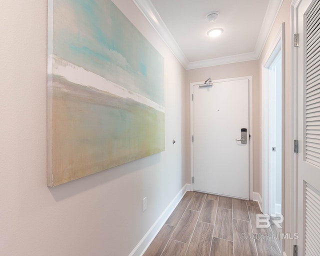 hallway with baseboards, ornamental molding, and wood tiled floor