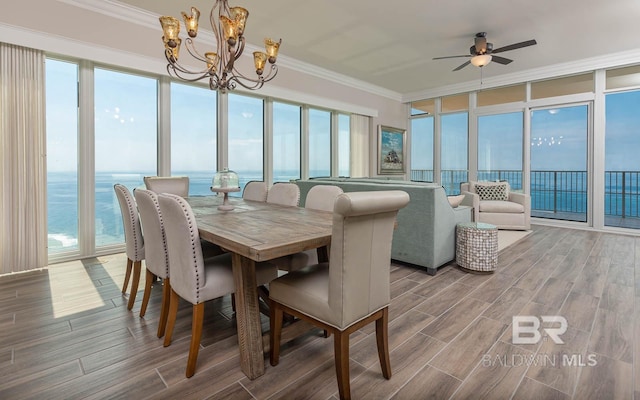 sunroom with plenty of natural light and a notable chandelier