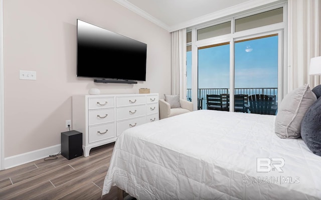 bedroom featuring crown molding, access to outside, wood finish floors, and baseboards