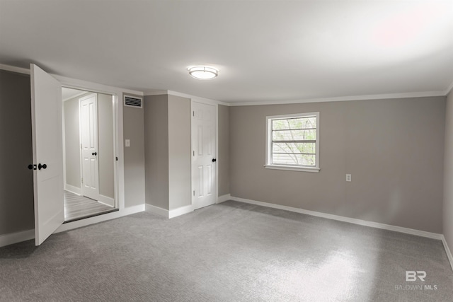 unfurnished bedroom with crown molding and carpet