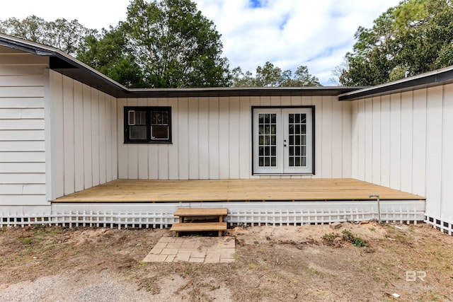 view of exterior entry with a wooden deck and french doors