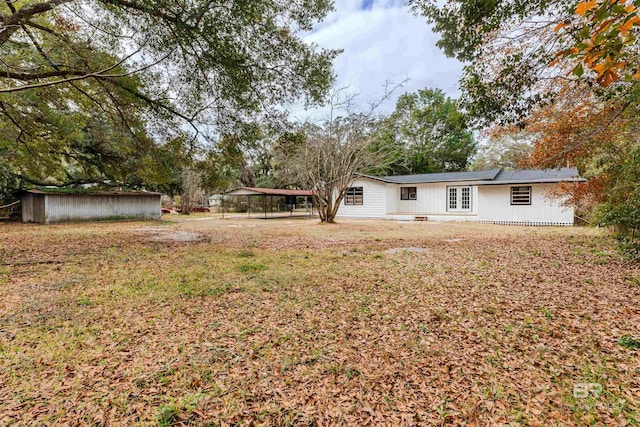 view of yard with a storage shed and a carport