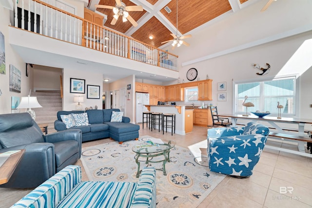 living room featuring light tile patterned floors, coffered ceiling, wooden ceiling, beamed ceiling, and a high ceiling