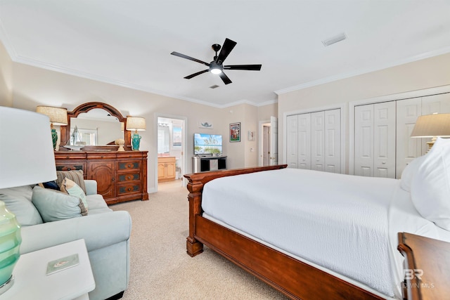 bedroom with carpet floors, multiple closets, visible vents, ornamental molding, and a ceiling fan