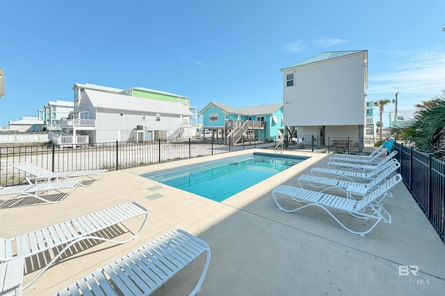 pool featuring fence and a patio