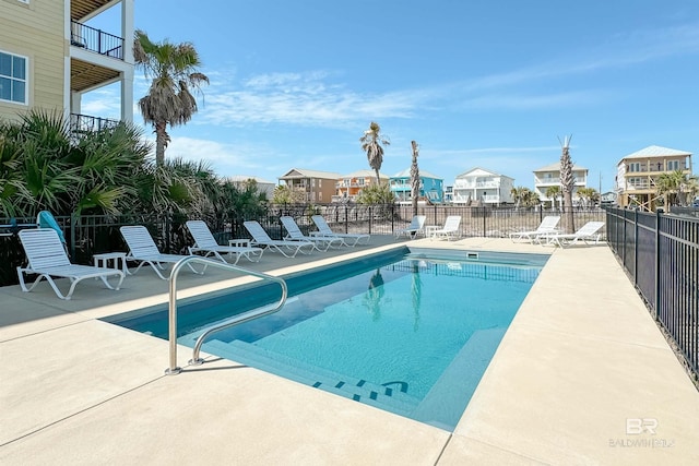 community pool featuring a patio area and fence