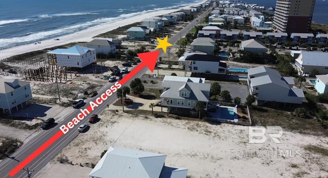 drone / aerial view featuring a view of the beach and a water view