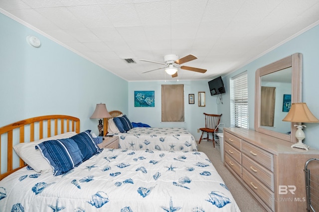 bedroom with ceiling fan, crown molding, and light carpet