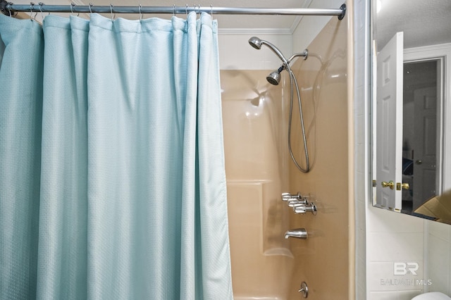 bathroom featuring ornamental molding and shower / tub combo with curtain