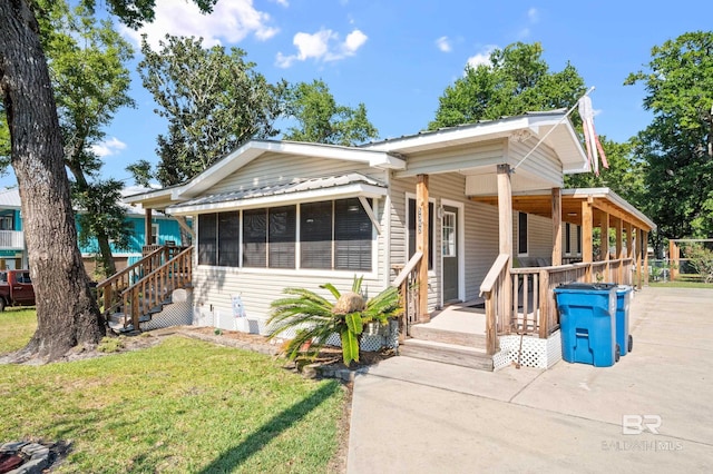 bungalow-style home with a sunroom