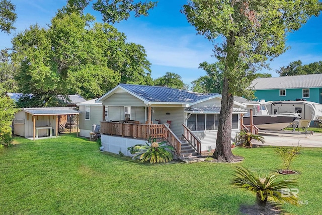 back of house featuring a sunroom and a yard