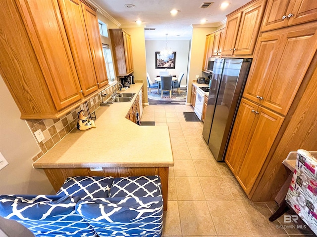 kitchen featuring hanging light fixtures, ornamental molding, sink, and appliances with stainless steel finishes