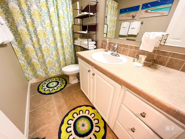 bathroom with decorative backsplash, tile patterned flooring, vanity, and toilet