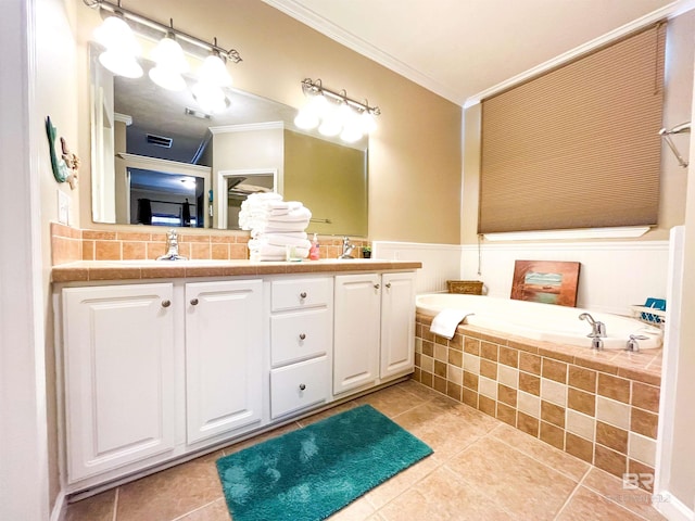 bathroom with tile patterned floors, vanity, crown molding, and tiled bath