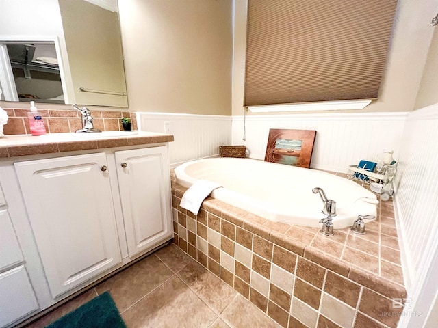 bathroom featuring vanity, tiled bath, and tile patterned floors