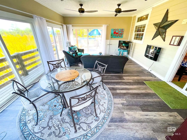 sunroom featuring ceiling fan and a healthy amount of sunlight