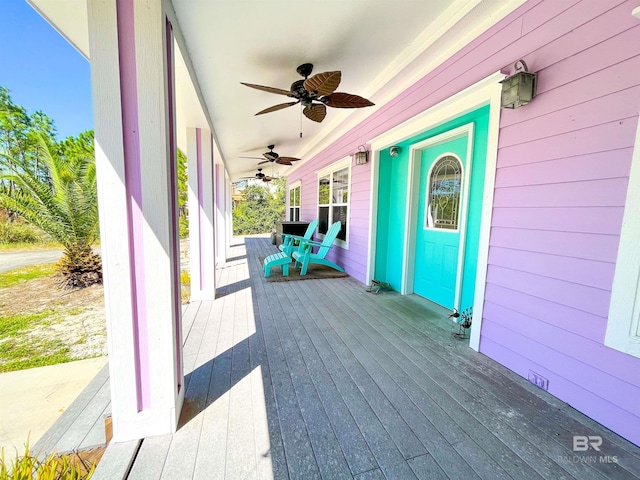 wooden terrace featuring ceiling fan and a porch