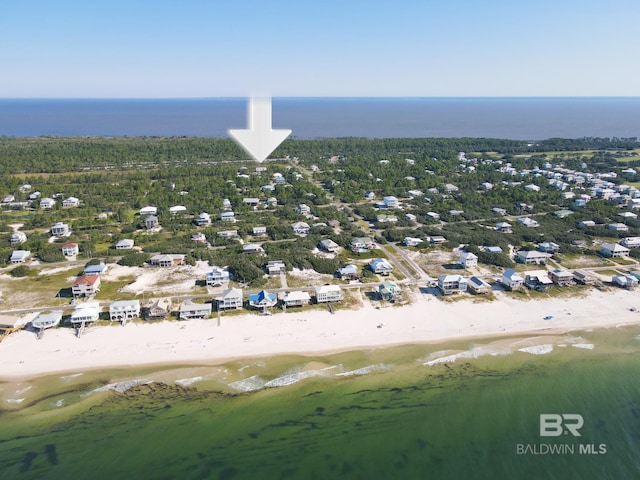 bird's eye view featuring a water view and a beach view