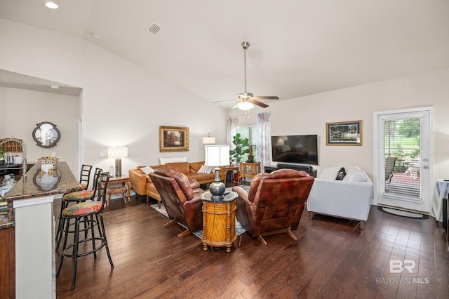 living room featuring dark hardwood / wood-style flooring, ceiling fan, and lofted ceiling