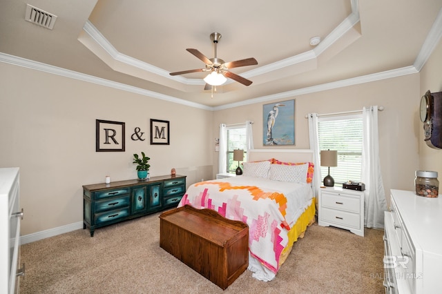 carpeted bedroom featuring a raised ceiling, ceiling fan, and crown molding