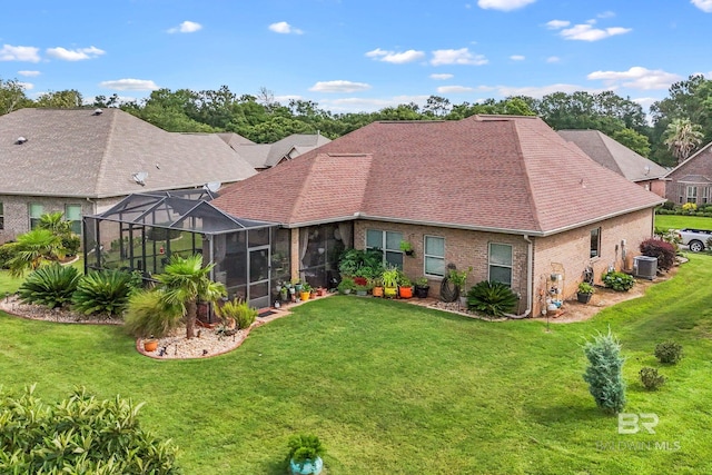 rear view of house featuring a lawn, glass enclosure, and cooling unit