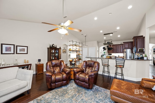 living room with ceiling fan, dark hardwood / wood-style flooring, and lofted ceiling