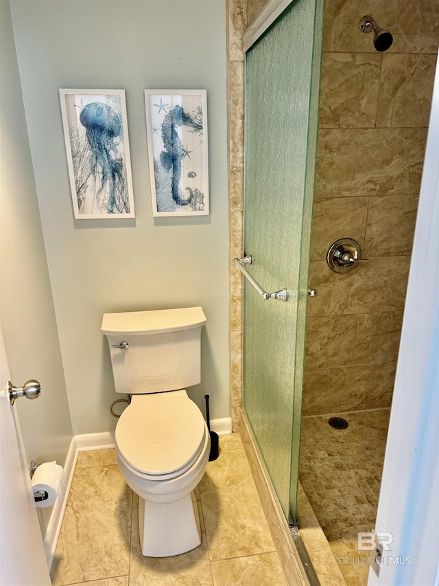 bathroom featuring toilet, an enclosed shower, and tile patterned flooring