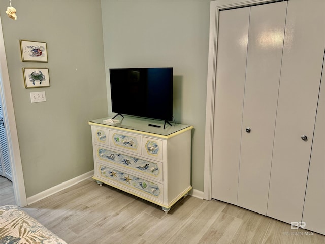 bedroom featuring a closet and light hardwood / wood-style flooring